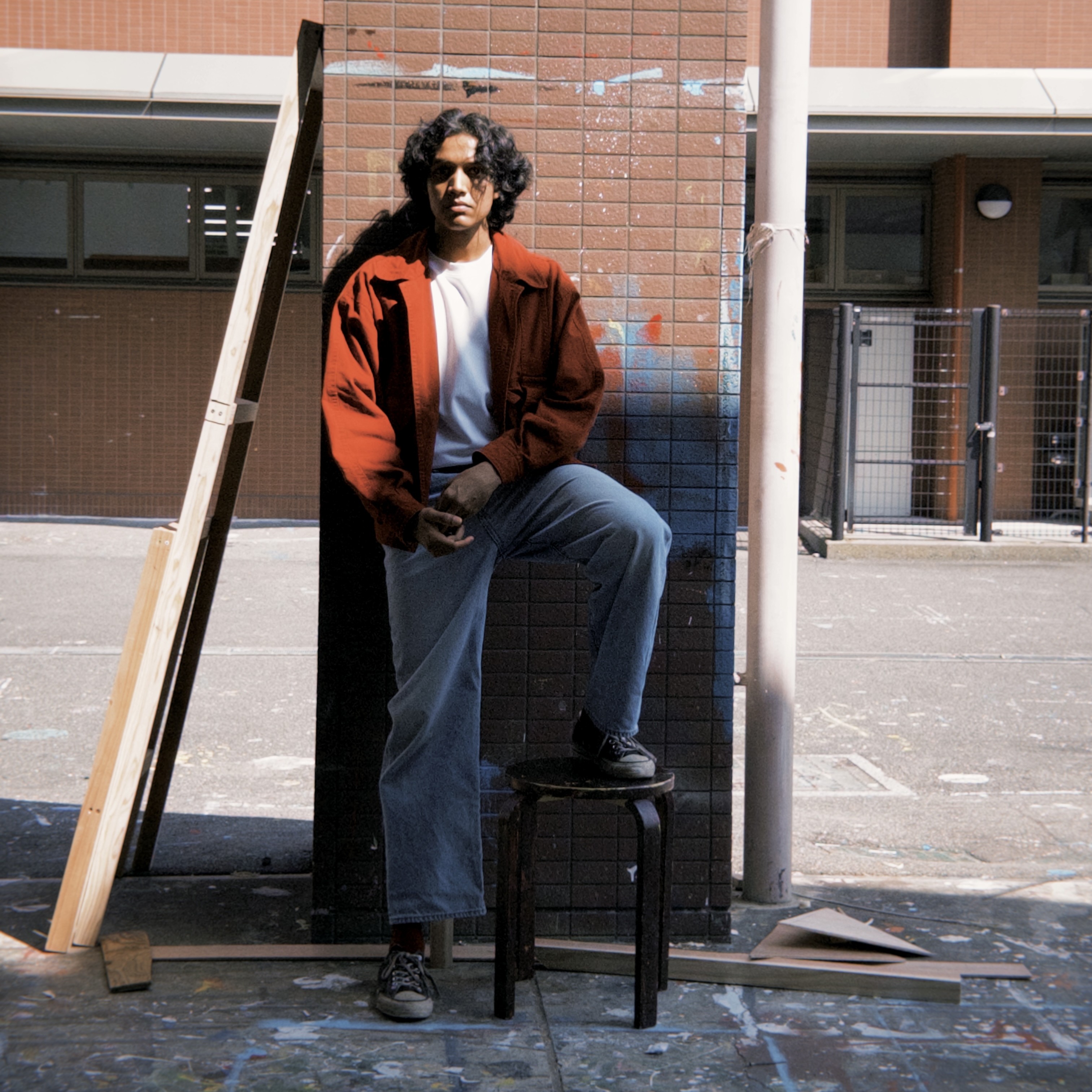 Portrait of a smiling young man with curly hair in black and white